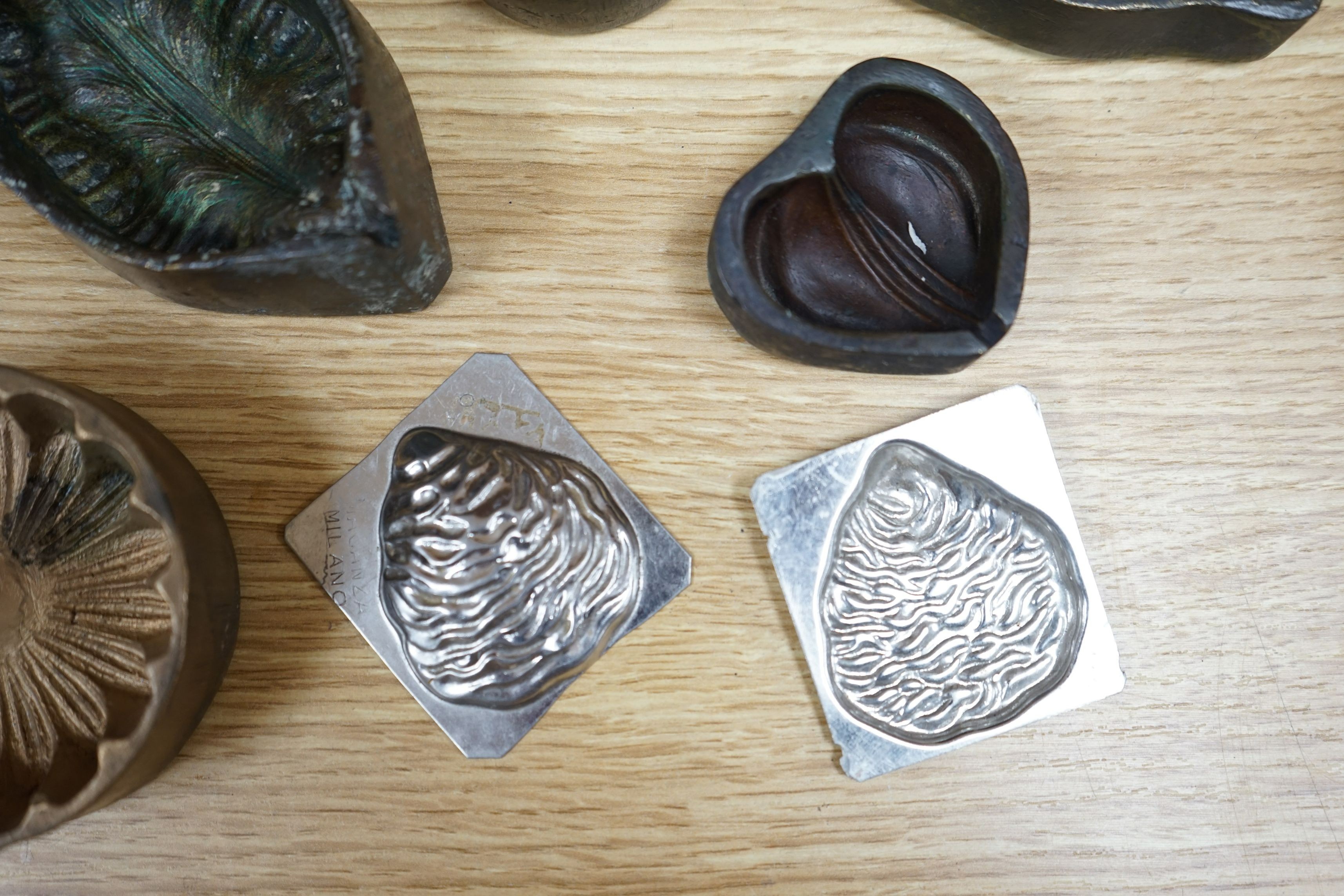 A collection of metal pattern moulds possibly for embossing silk (19) and two other moulds